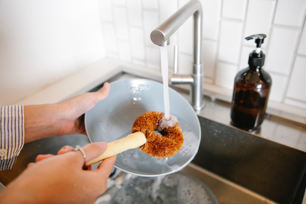 woman washing dishes in kitchen