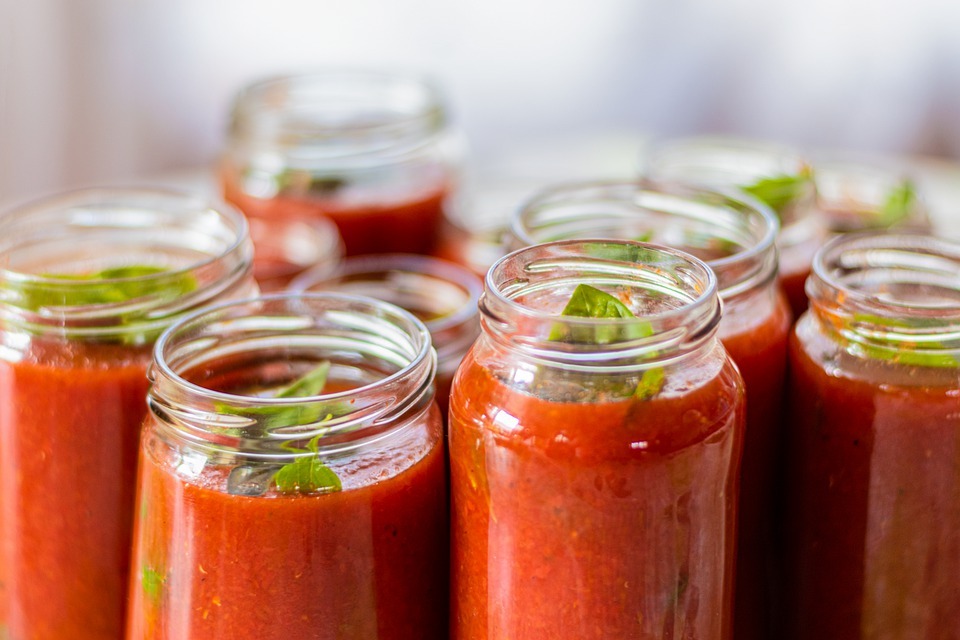 a picture of opened jars filled with tomato sauce
