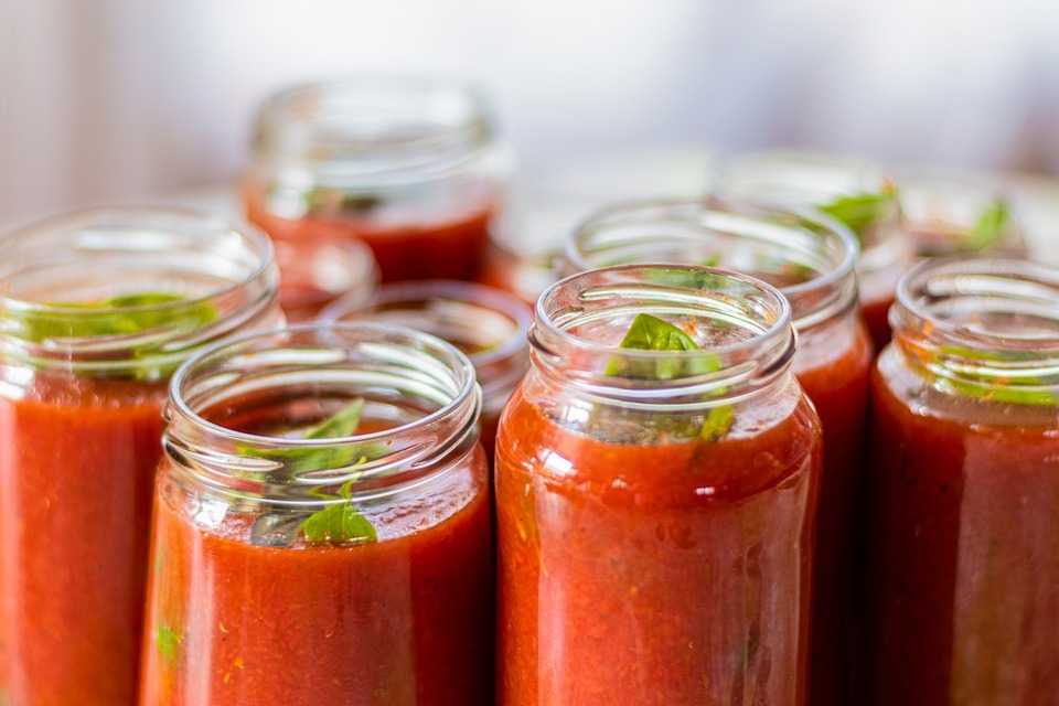 a picture of opened jars filled with tomato sauce 