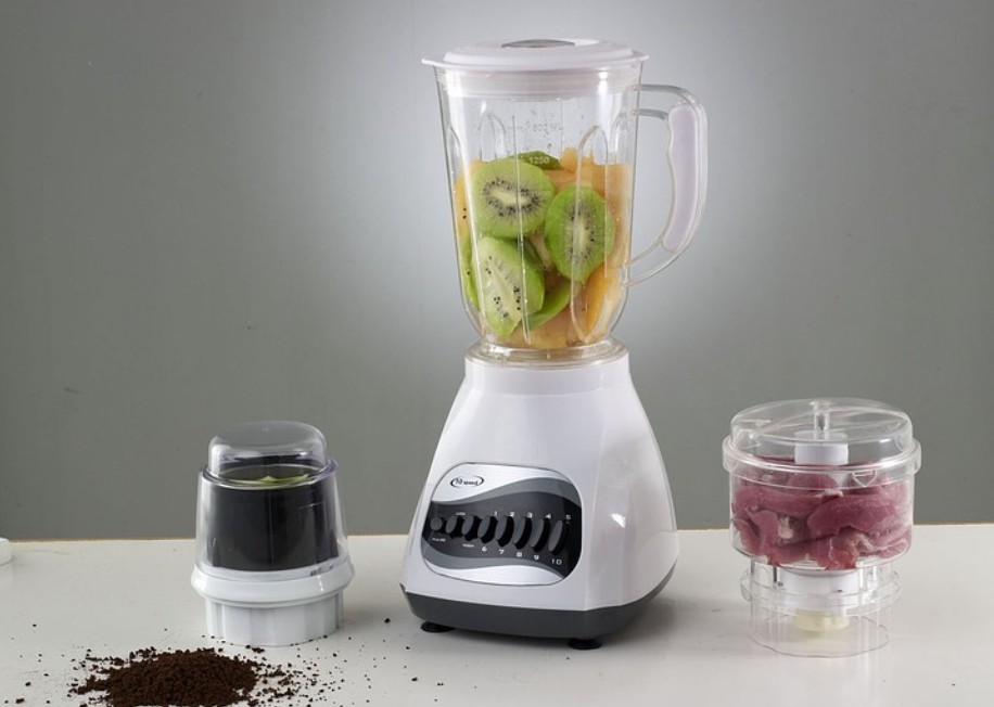 fruits inside a blender, coffee spilled coffee grounds, and food inside a chopper