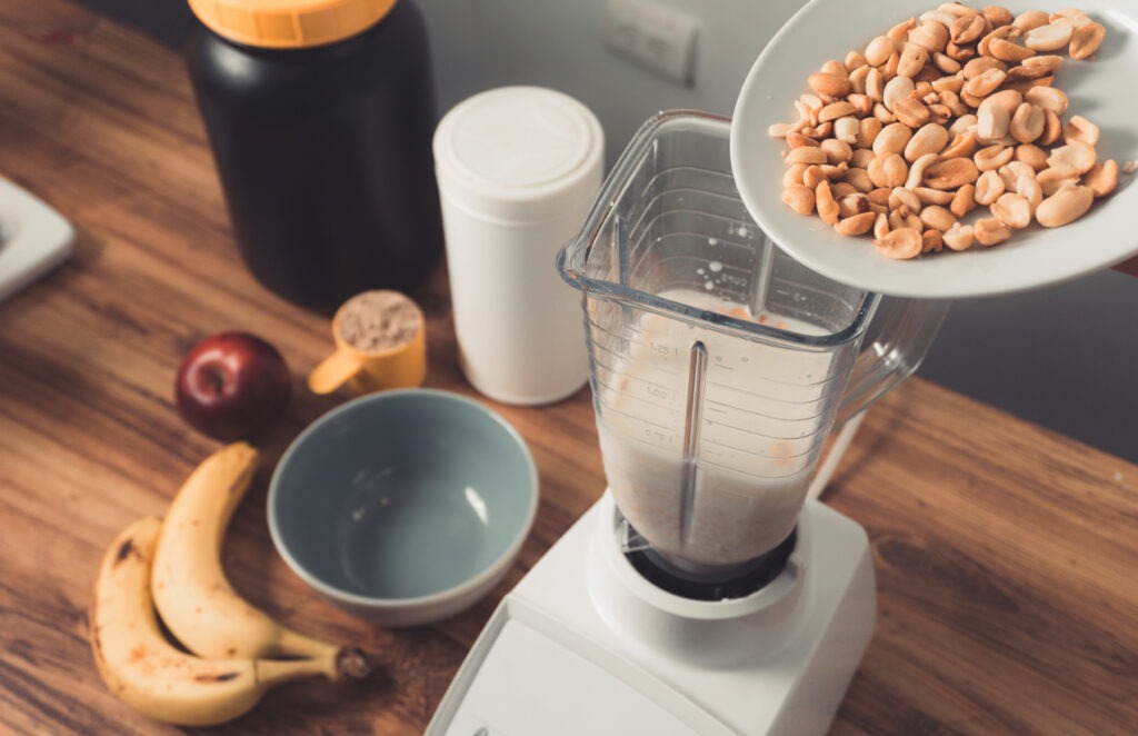 preparation-of-a-protein-smoothie-by-adding-a-cup-of-roasted-peanuts